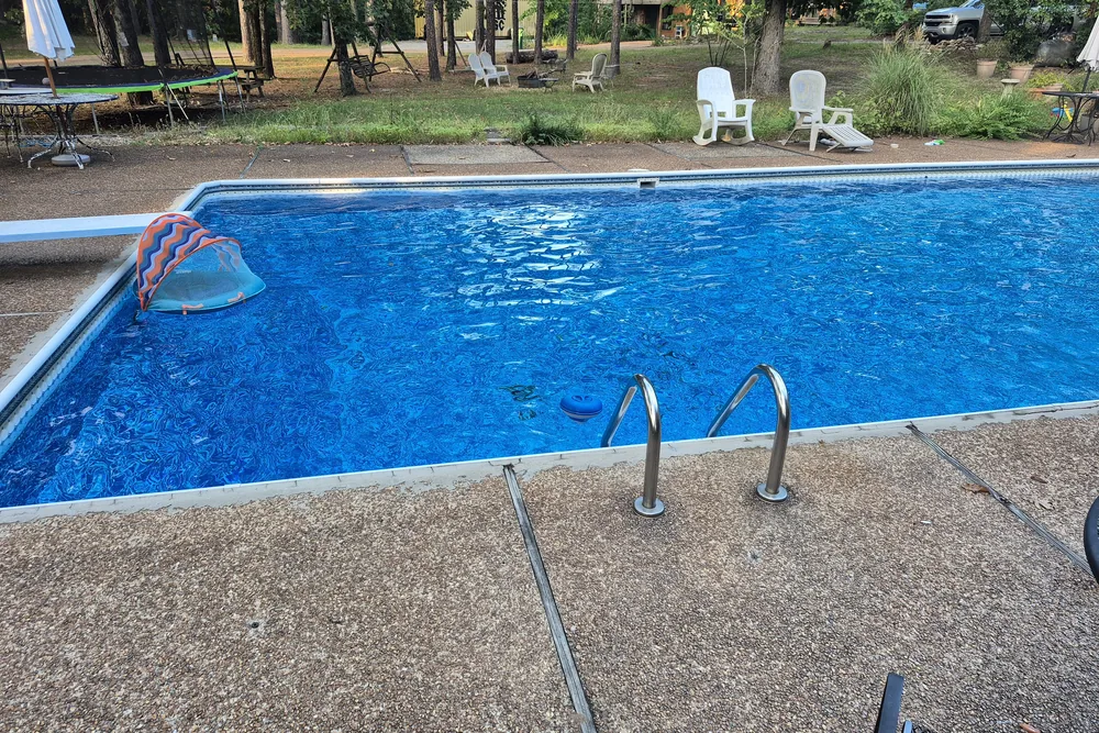 A well-maintained backyard pool at golden hour