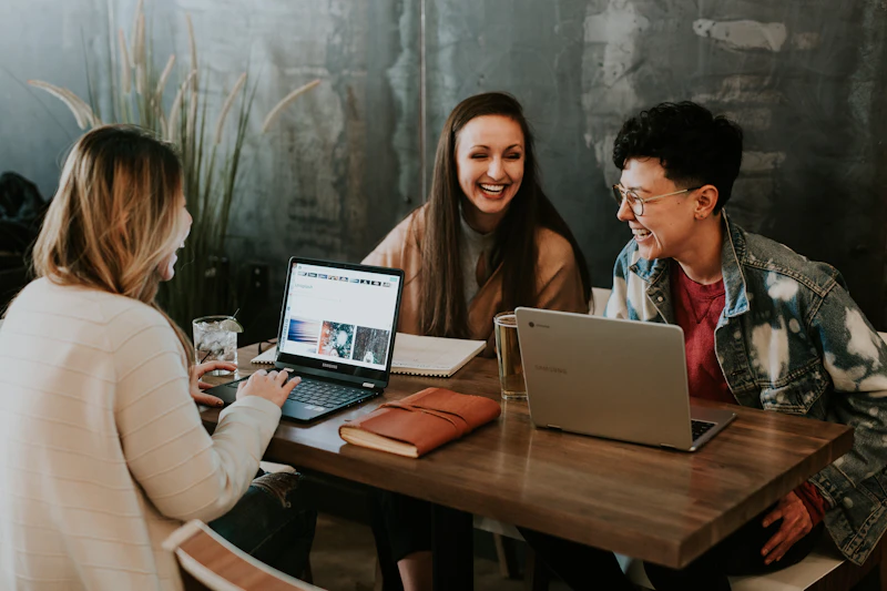 Remote professionals collaborating over laptops during a client meeting